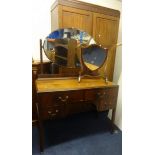 A mahogany two door wardrobe, a dressing table and a dressing table 'shield' mirror (3)