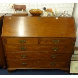 A Georgian mahogany bureau of large proportions, with a fitted interior, two short and three long