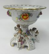 A 20th century porcelain centrepiece decorated with cherubs and flowers.