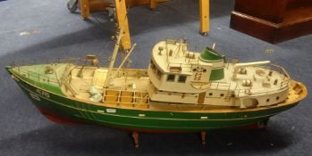 An old fishing boat model and a pair of fisher folk figures (damaged)