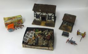 A collection of lead farmyard animals and buildings