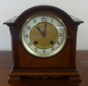 A mahogany cased mantle clock with 8 day movement striking on a gong, with key