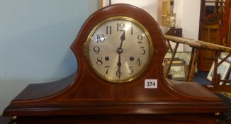 A large mahogany and inlaid cased chiming mantle clock with key