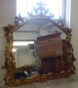 A reproduction ornate framed mantle mirror of Victorian style.