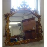 A reproduction ornate framed mantle mirror of Victorian style.