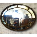 A large 19th century oval wall mirror with gilt frame.