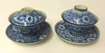 A pair of fine Chinese bowls with covers and stands, metal rims probably for the Vietnamese market