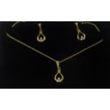 A pair of 9ct diamond set earrings and matching pendant on fine gold chain.