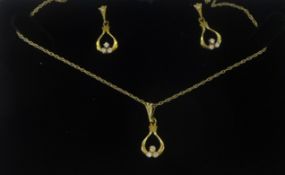 A pair of 9ct diamond set earrings and matching pendant on fine gold chain.