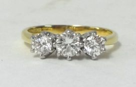 A modern three stone diamond set ring, approx 0.75 carats, finger size M, (with original receipt).