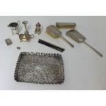 A silver embossed tray, 24cm x 19cm, a four piece silver back dressing table set, silver cream