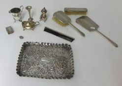 A silver embossed tray, 24cm x 19cm, a four piece silver back dressing table set, silver cream