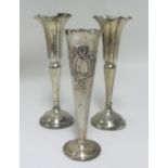 A pair Geo V silver spill vases, height 20cm and another (3)