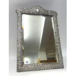 A late Victorian silver mounted dressing table mirror, the rectangular easel back frame with