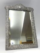 A late Victorian silver mounted dressing table mirror, the rectangular easel back frame with
