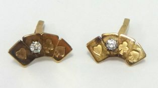 A pair 9ct gold cufflinks, modelled as a set of bridge cards set with a diamond, approx 6.90gms.