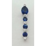 A 18ct white gold sapphire and diamond pendant, length 25mm.