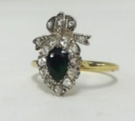 An 18ct Georgian emerald and diamond set ring, with a diamond set bow above, finger size Q.