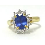 An 18ct tanzanite and diamond cluster rings, approx 1.30 carats, finger size N.
