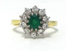 An 18ct emerald and diamond cluster ring.