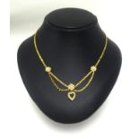 A pretty 15ct gold half pearl heart necklace.