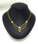 A pretty 15ct gold half pearl heart necklace.