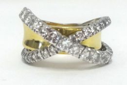 A large and impressive 18ct diamond cross over band ring, finger size S.