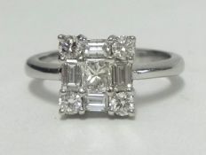 An 18ct white gold diamond ring, of square form set with an arrangement of round and baguette cut