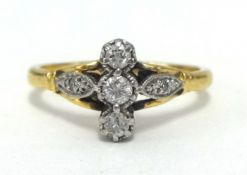 An 18ct small diamond three stone ring, finger size M.