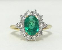 An emerald and diamond cluster ring, ring size N.
