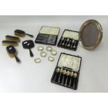 Four piece silver and tortoiseshell dressing table set, an oval silver photo frame, six silver