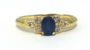 A sapphire and diamond ring, stamped 585, finger size Q.
