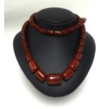 An amber style necklace, 87.20gms.