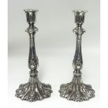 A pair of white metal candlesticks, height 27cm.