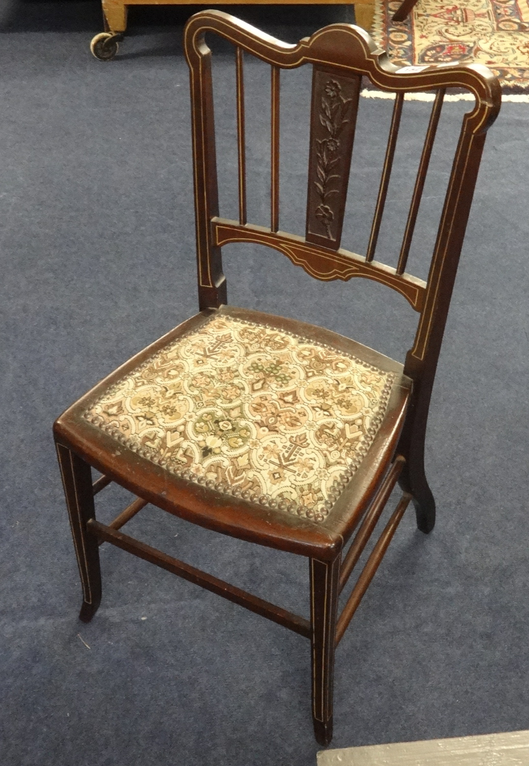 An Edwardian bedroom chair with inlaid decoration.