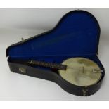 An eight string banjo/ mandolin cased.