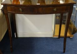 A reproduction mahogany hall table fitted with two drawers on sabre legs.