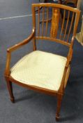 An Edwardian mahogany inlaid elbow chair.