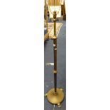 A brass rising standard lamp