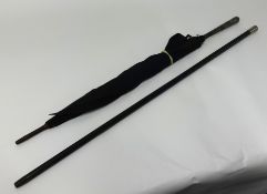 A Chinese white metal (silver?) umbrella and an ebony and silver mounted walking cane (2).
