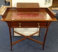 A mahogany writing table with upper stationary compartment.
