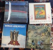 Collection of vinyl records (albums) by Wings, including Wings over America, Wings Venus and Mars,