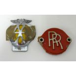 A Rolls Royce (RR) radiator cap and an AA badge (2).