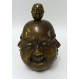 A large bronze four face Buddha head and a similar miniature model (2).