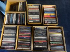 A collection of CDs including The Beatles, Queen and The Rolling Stones.