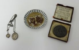 A RMS Lusitania propaganda medal coin, within the original box, a silver pendant and a Great War