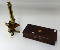 A brass microscope, other objects, prayer books, Eric Wilson book, open face pocket watch etc.