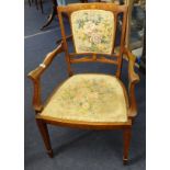 An Edwardian inlaid mahogany elbow chair.