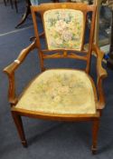An Edwardian inlaid mahogany elbow chair.