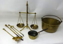 A large brass jam pan, a brass skillet, set of brass scales, weights and fire irons.
